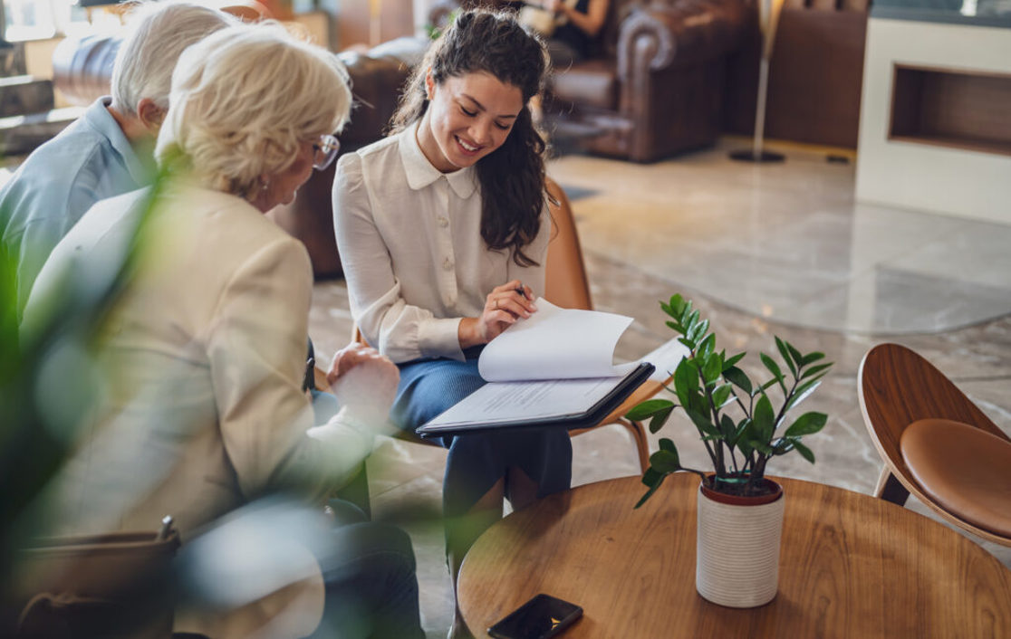 A pensions adviser showing her customers some common pension mistakes