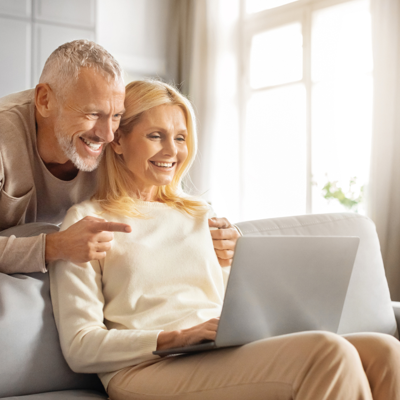 Senior man and woman looking at laptop