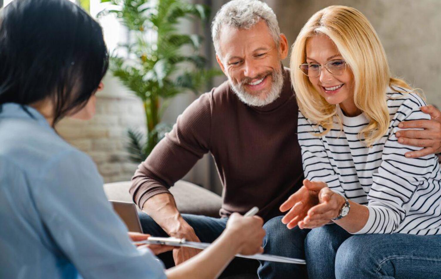 A couple having a conversation with a female adviser