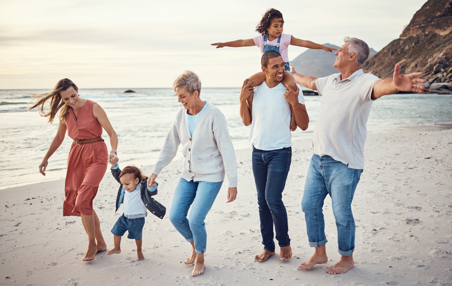Couple enjoying retirement on beach with family