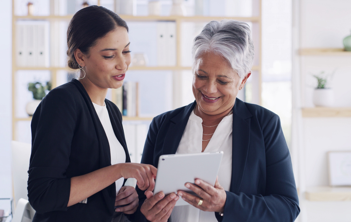 two business women discussing looking at a tablet 